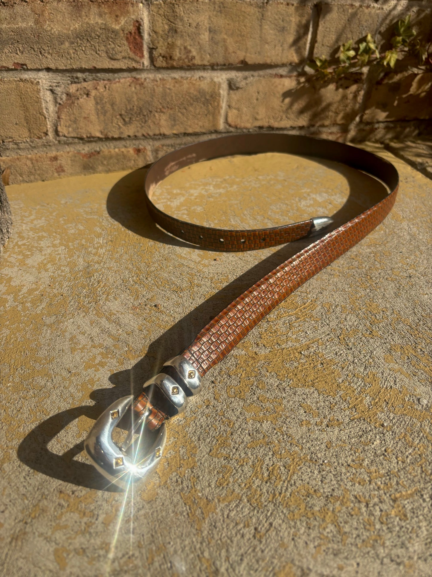 Brown embossed leather / silver tone buckle belt - 42